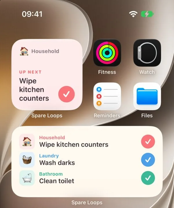 An iPhone home screen with two Spare Loops widgets: one showing Wipe kitchen counters up next in the Household loop, and one listing the next chore in each loop with a check button